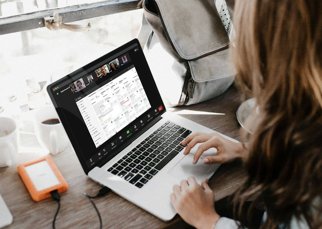 Photo of a person attending a Karbon demo webinar on a laptop.
